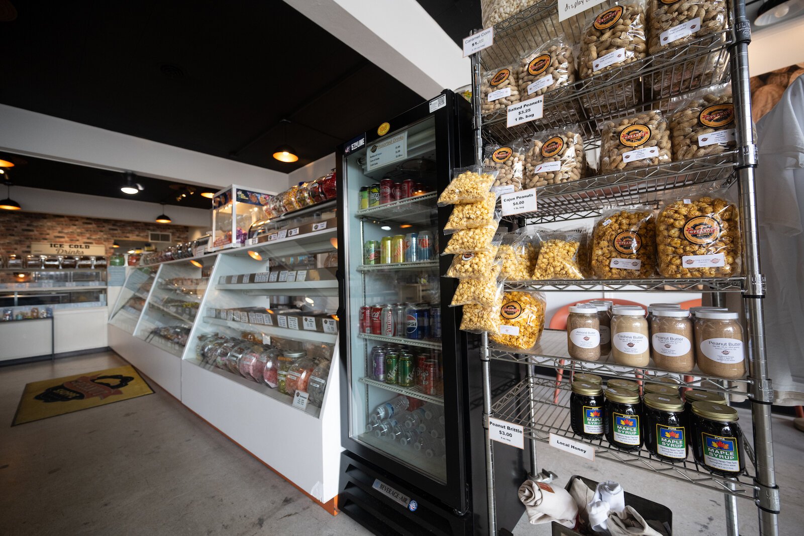 Peanuts, syrups, and candies line the shelves and display cases at The Peanut Shoppe.