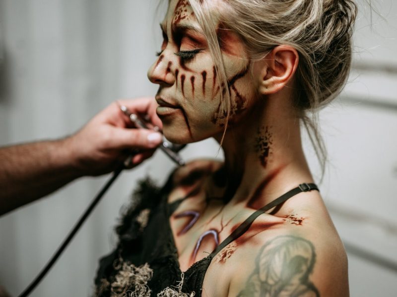 A scare actor gets her makeup done before the haunt opens.